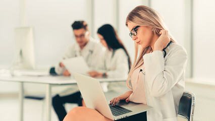 doctor uses a laptop to work with documents