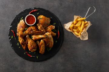 Mix of baked chicken pieces.