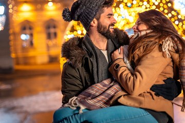 Couple celebrating Christmas on city streets