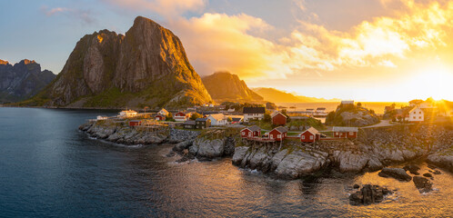 Red wooden huts, known as Rorbu, in the village of Reine on the Hamnoy island, Lofoten Islands,...