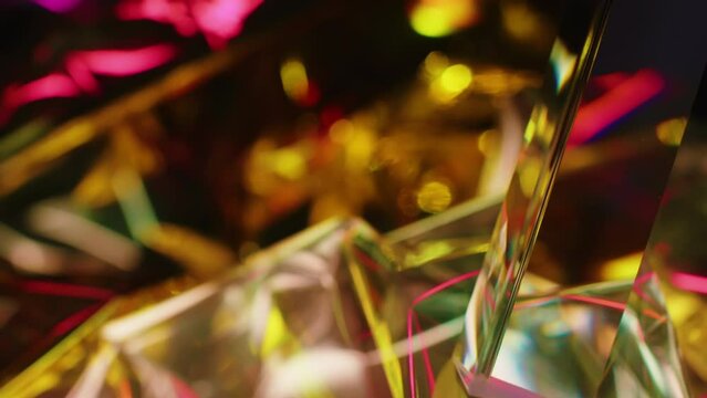 Abstract background with glass prism reflecting light in golden and red shiny particles