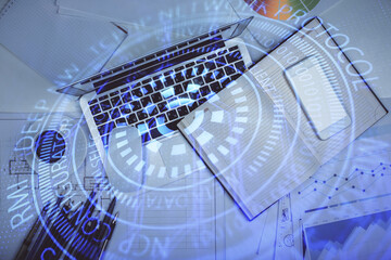 Multi exposure of data drawing hologram over topview of study desk background with computer. Concept of technology.