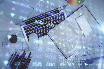 Multi exposure of forex chart drawing over table background with computer. Concept of financial research and analysis. Top view.