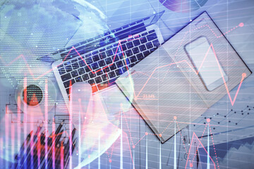 Multi exposure of forex chart drawing over table background with computer. Concept of financial research and analysis. Top view.