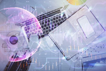Multi exposure of forex chart drawing over table background with computer. Concept of financial research and analysis. Top view.