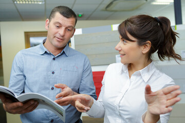 teamwork looking at a catalogue