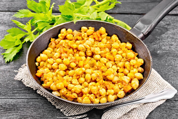 Chickpeas stewed with vegetables in pan on board