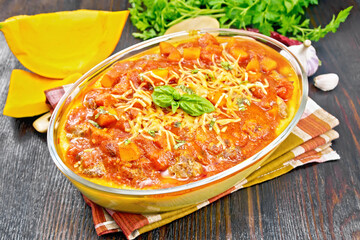Porridge corn with meat and vegetables in roaster on dark board
