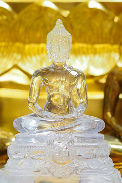 The face of a white Buddha image made of glass.