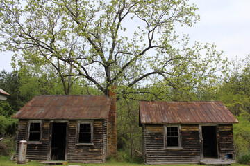 Historical slave houses sitting in a field