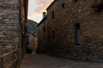 Fototapeta na wymiar stone street in the town of oto at the entrance of the e ordesa national park in the spanish pyrenees at sunset