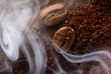 Ground coffee and coffee beans, coffee in light smoke.