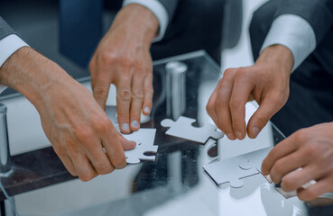 close up.business partners put the puzzle together