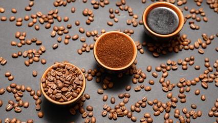 Three cups with different coffee, coffee beans, ground and ready-made drink.