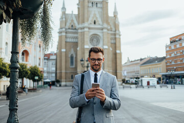 Close up shot of businessman's hand holding smart phone. Communication technology concept. Cinematic color grade.