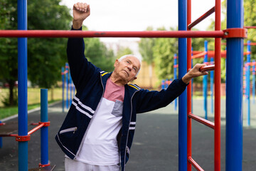 Obraz premium Old man warming up before training outdoors