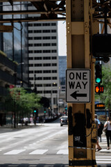 One way street sign under a railway in the middle of Chicago 