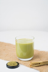 green tea and green tea powder on whiteblackground