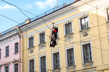 An automobile traffic light over the road against the backdrop of a historic building in St. Petersburg. Svefor red signal