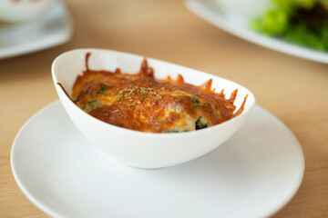 Baked Spinach with Cheese in white bowl.