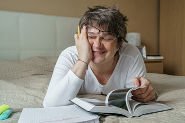 Young woman smiling while studying at home