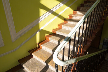 Photo of staircase in residential house. Typical building in historical center in Saint Petersburg, Russia. Steps with forged fence. apartment house.