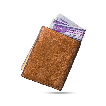 3D rendering of Ethiopian birr notes popping out of a brown leather men’s wallet. Ghanaian cedi  in wallet