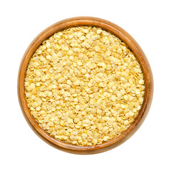 Bell pepper seeds, in a wooden bowl. Dried slightly yellow seeds of Capsicum annuum, also known as paprika, sweet pepper or capsicum, prepared for sowing and growing new pepper plants. Close up photo.