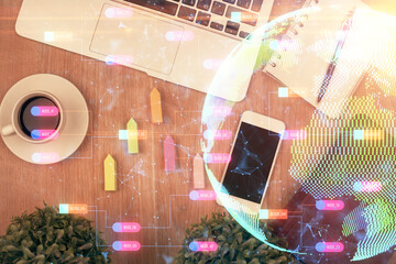 Double exposure of map hologram drawing over desktop. Top view. International connection concept.