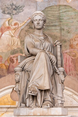Fototapeta na wymiar Marble statue of roman goddess inside church in Pisa