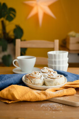 Baked apples in puff pastry sprinkled with powdered sugar. Breakfast with a cup of tea on the table.