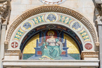 Religious fresco under arch on exterior facade of catholic basilica in Pisa