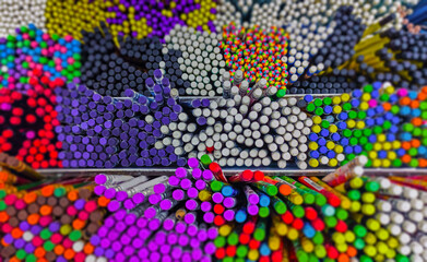 Fototapeta na wymiar Multicolored pencils in art store closeup, selective focus. Art concept background. 
