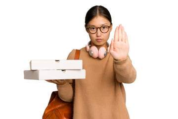 Young student Asian woman holding pizzas isolated on green chrome background standing with outstretched hand showing stop sign, preventing you.
