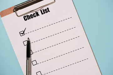 Pen tick mark sign with check list paper sheet and clipboard on blue background for to do list or planing concept.