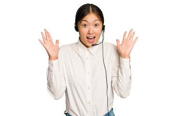Telemarketer asian woman working with a headset isolated on green chroma background receiving a...