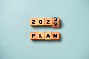Flipping of wooden block cube to change 2022 to 2023 and plan wording for business planing of nee...