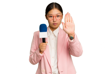 Young TV Asian presenter isolated on green chroma background standing with outstretched hand showing stop sign, preventing you.