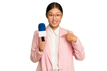 Young TV Asian presenter isolated on green chroma background person pointing by hand to a shirt copy space, proud and confident