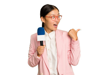 Young TV Asian presenter isolated on green chroma background points with thumb finger away, laughing and carefree.