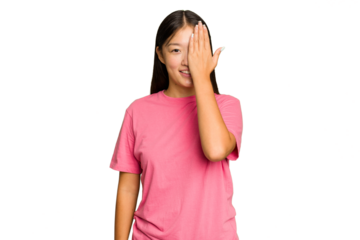 Young Asian woman isolated on green chroma background having fun covering half of face with palm.