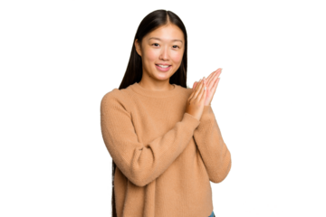 Young Asian woman isolated on green chroma background feeling energetic and comfortable, rubbing hands confident.