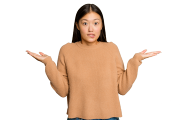 Young Asian woman isolated on green chroma background confused and doubtful shrugging shoulders to hold a copy space.