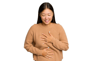 Young Asian woman isolated on green chroma background laughs happily and has fun keeping hands on...