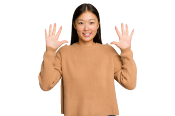 Young Asian woman isolated on green chroma background showing number ten with hands.