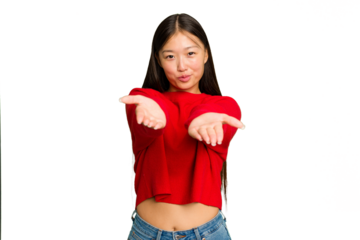 Young Asian woman isolated on green chroma background folding lips and holding palms to send air kiss.