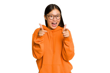 Young Asian woman isolated on green chroma background cheerful smiles pointing to front.