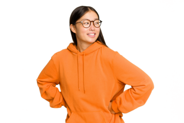 Young Asian woman isolated on green chroma background laughs happily and has fun keeping hands on stomach.