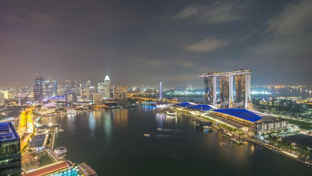 Singapore time lapse 4K, high angle view city skyline night timelapse at Marina Bay business district