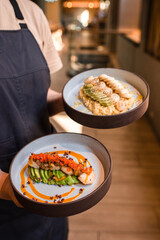 asian food in the hands of a waiter in a Japanese restaurant